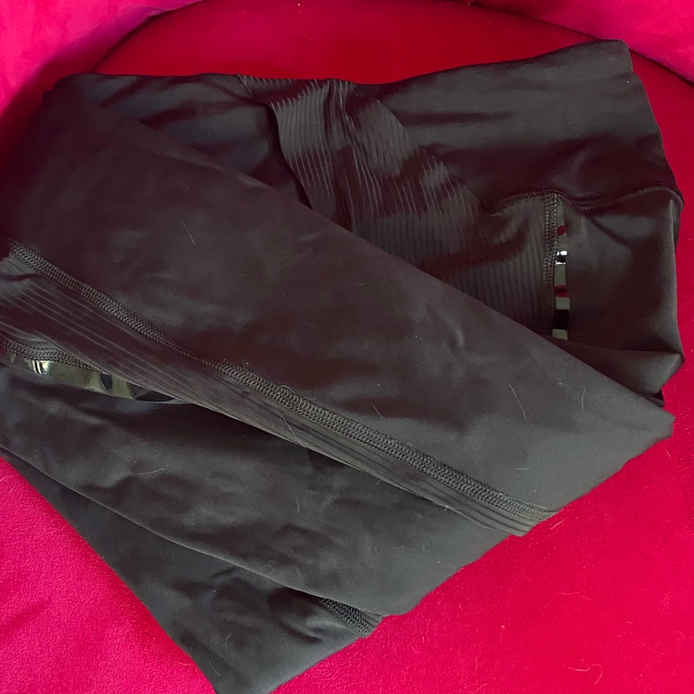 High waisted size 4 black shiny stripe on black leggings. Stripe entire of 25”.